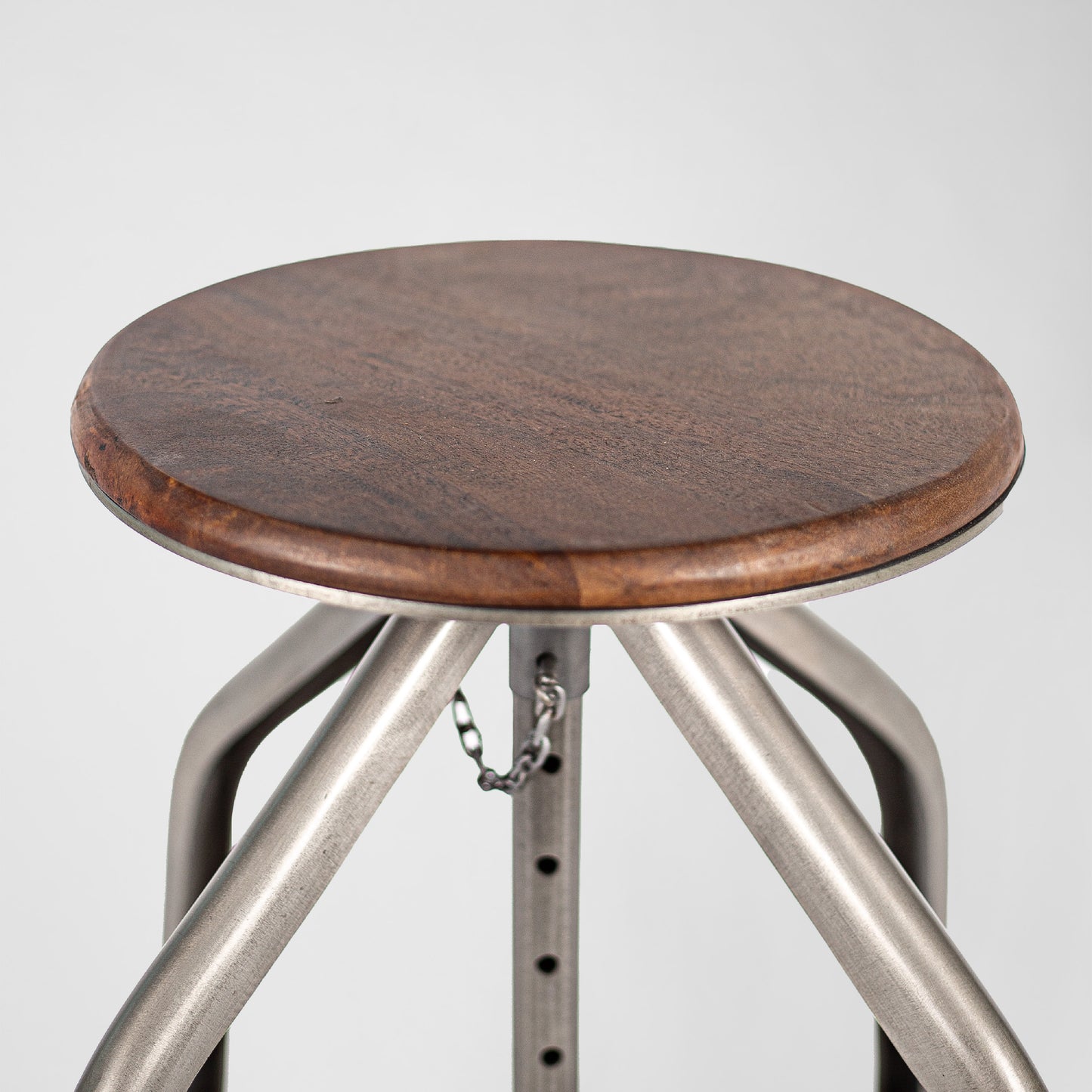 Humphrey Pump – Handmade industrial design stool made of metal with wooden seat in silver
