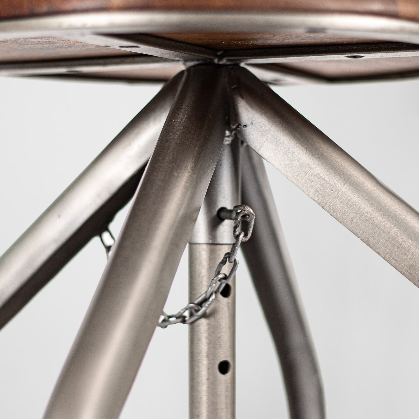 Humphrey Pump – Handmade industrial design stool made of metal with wooden seat in silver